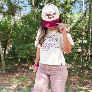 Person wearing a 'Texas A&M Aggies' cap and shirt outdoors-ava wray boutique