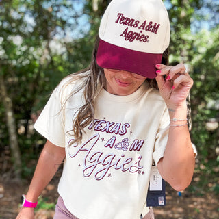 Person wearing a 'Texas A&M Aggies' t-shirt and cap outdoors-ava wray boutique