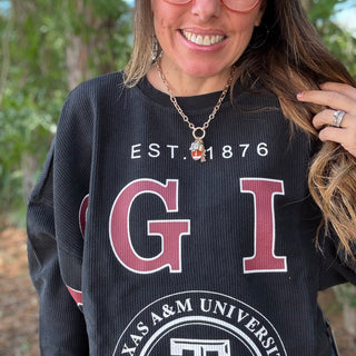 Person wearing a black Texas A&M University sweatshirt with visible branding-ava wray boutique