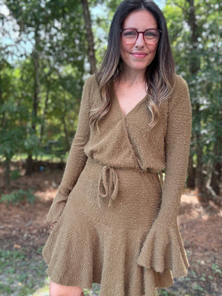 Woman wearing a green dress in a forest setting- ava wray boutique