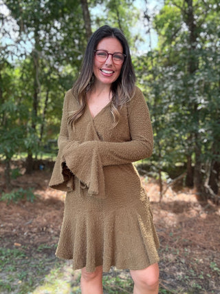 Woman wearing a green dress in a forest setting- ava wray boutique