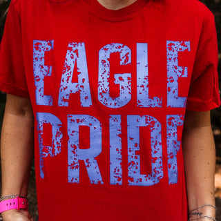 Red t-shirt with blue 'EAGLE PRIDE' text worn by a person-ava wray boutique