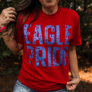 Person wearing a red t-shirt with 'Eagle Pride' printed in blue-ava wray boutique