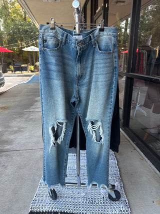 Kancan Denim Blue jeans with distressing on a stand outdoors