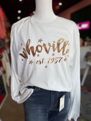 White long-sleeve shirt with 'whoville est. 1957' text on a mannequin in a store setting.