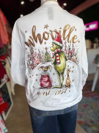 White shirt with 'Whoville' graphic design featuring characters and text, worn by a person.
