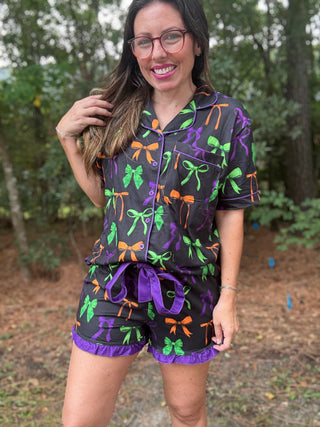 Woman wearing a colorful pajama set with bows in an outdoor setting-ava wray boutique