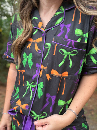 Person wearing a pajama set with colorful bow pattern-ava wray boutique