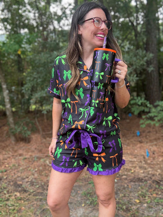 Woman wearing a colorful outfit with bows in an outdoor setting-ava wray boutique