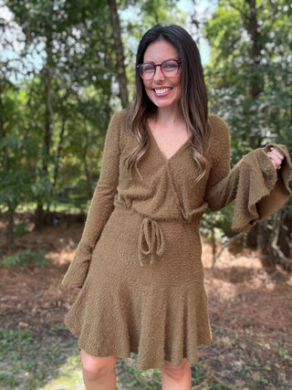 Woman wearing a green dress in a forest setting- ava wray boutique