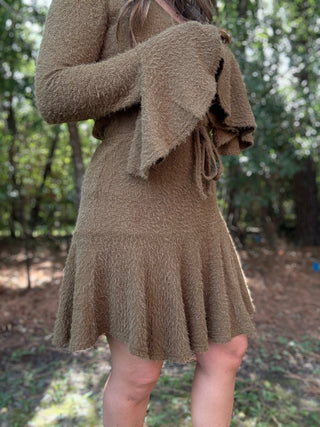 Woman wearing a green dress in a forest setting- ava wray boutique