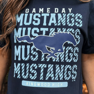 Navy blue t-shirt with 'Game Day Mustangs' text and horse graphic, featuring 'Kingwood High' on a blurred background-ava wray boutique