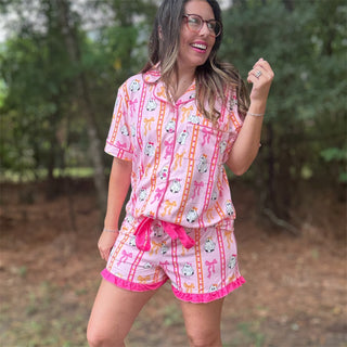 Woman wearing a pink pajama set with cartoon designs outdoors-ava wray boutique