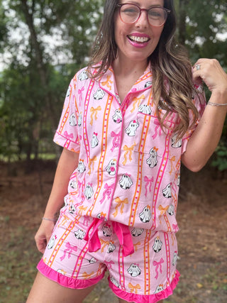 Woman wearing a pink pajama set with cartoon designs outdoors-ava wray boutique