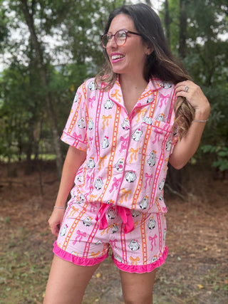 Woman wearing a pink pajama set with cartoon characters outdoors-ava wray boutique