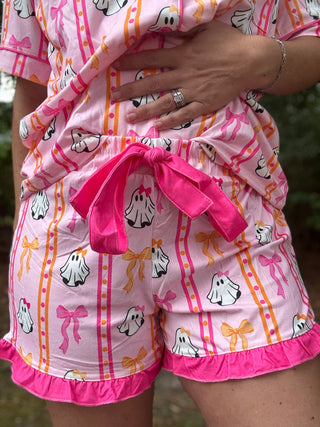 Pink pajama set with ghost and bow pattern on a blurred background=ava wray boutique